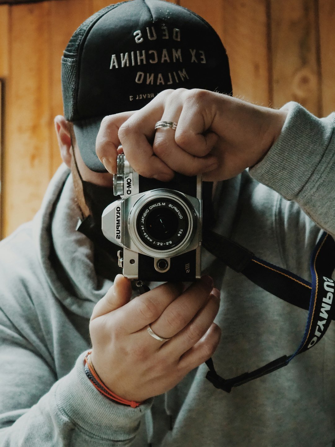 Portrait of a young Chilean male street photographer holding a camera
