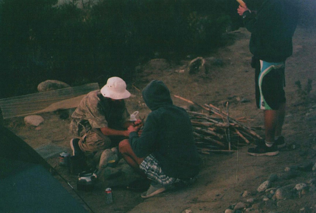 Group of three young Chilean photographers reviewing photos together